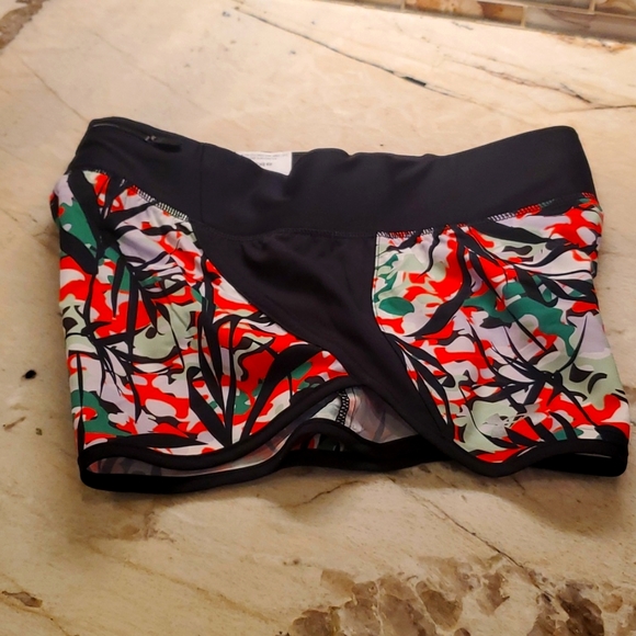 Woman's running short, black & multi. Zipper pouch in back. sm/p. Never worn - Picture 1 of 4